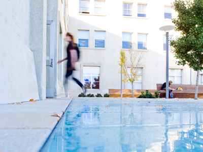 student walking outside of dwinelle hall